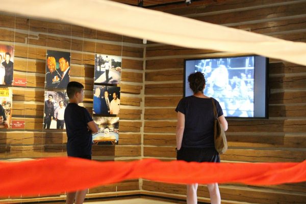 Karen Hauck, right, and Benny Quiles-Rosa watch a video about Muhammad Ali’s career in the gym at Fighter’s Heaven, Ali’s training camp in Deer Lake, Pa., on June 8, 2019. (Michael Rubinkam/AP Photo)
