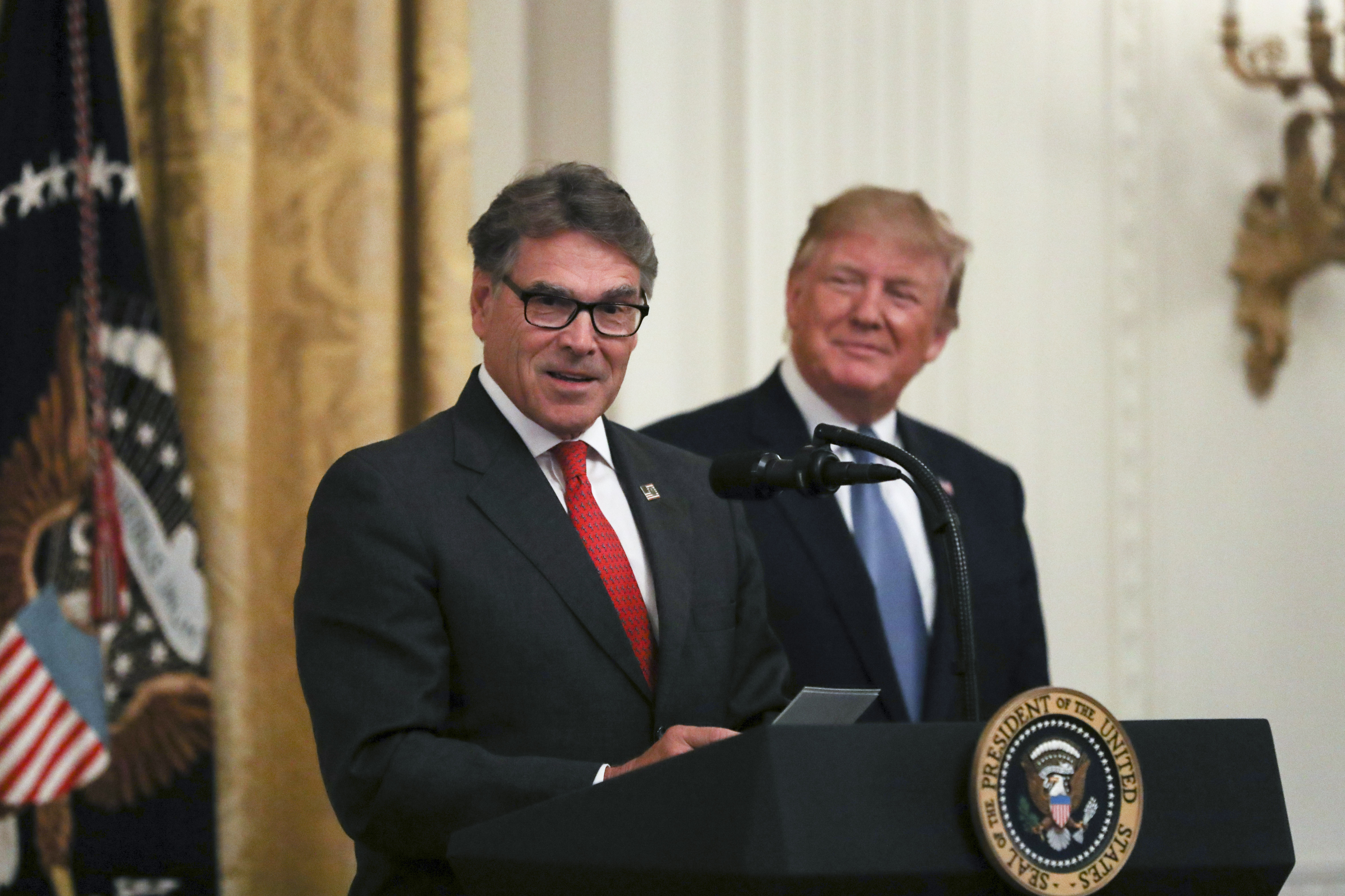 Secretary of Energy Rick Perry and President Donald Trump at the administration's environment initiative event in the East Room of the White House in Washington on July 8, 2019. (Charlotte Cuthbertson/The Epoch Times)