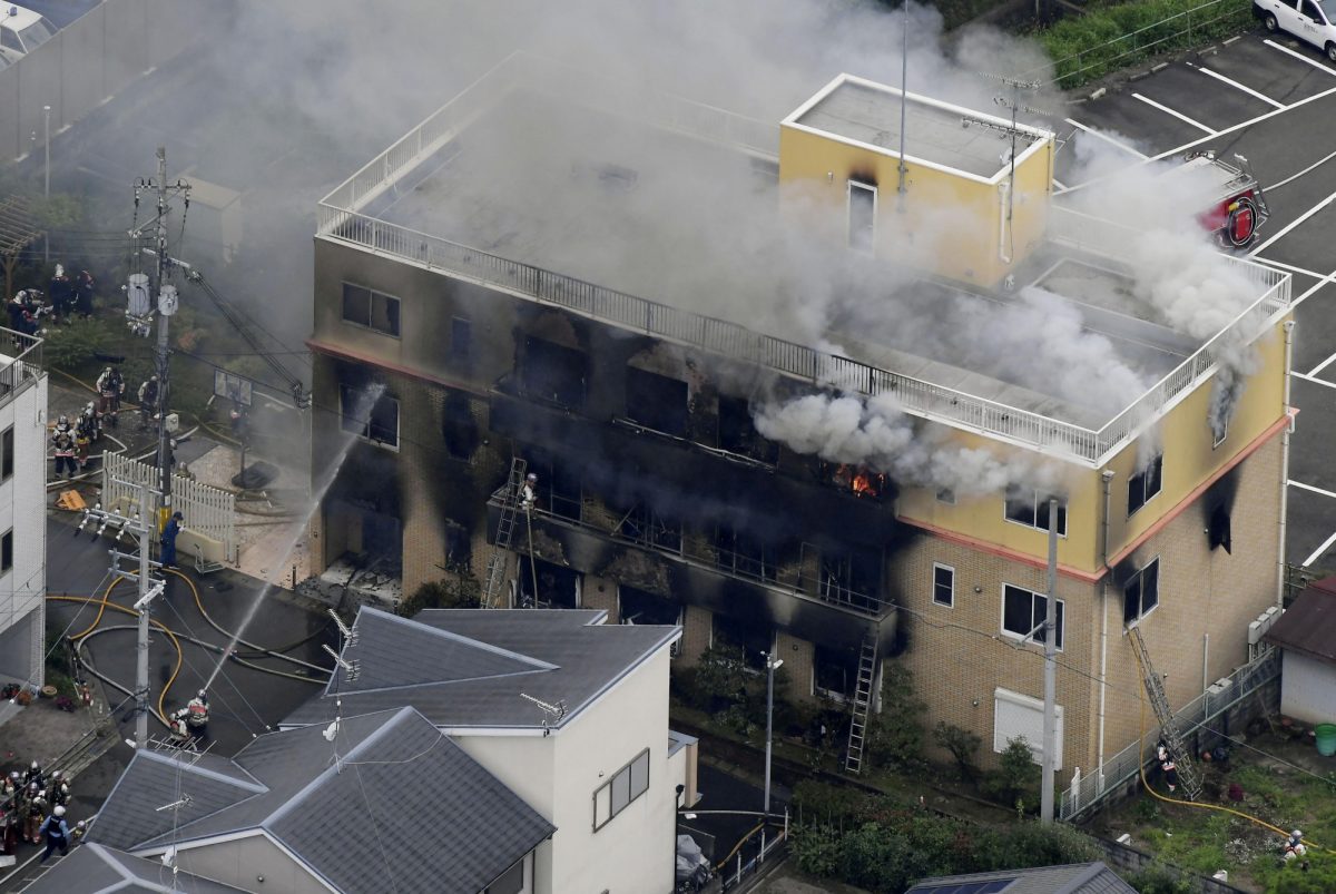 An aerial view shows firefighters battling fires at the site where a man started a fire after spraying a liquid at a three-story studio of Kyoto Animation Co. in Kyoto, western Japan, on July 18, 2019. (Kyodo/Reuters)
