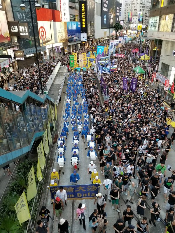 Falun Gong practitioners take part in a march in Hong Kong on July 1, 2019. (Song Bilong/The Epoch Times)