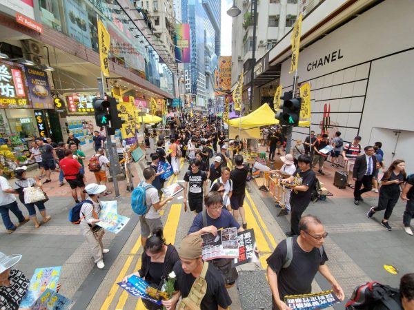 Some people wearing black walk on Great George Street on their way to Victoria Park to join the march on July 1, 2019. (Sun Qingtian/The Epoch Times)