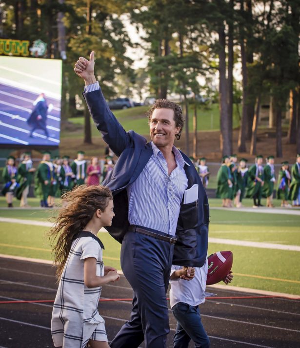 Actor and 1988 Longview High School graduate Matthew McConaughey takes the field with his children to deliver the commencement address at the school's graduation ceremony in Longview, Texas, on May 17, 2019. (Les Hassell/The News-Journal via AP)