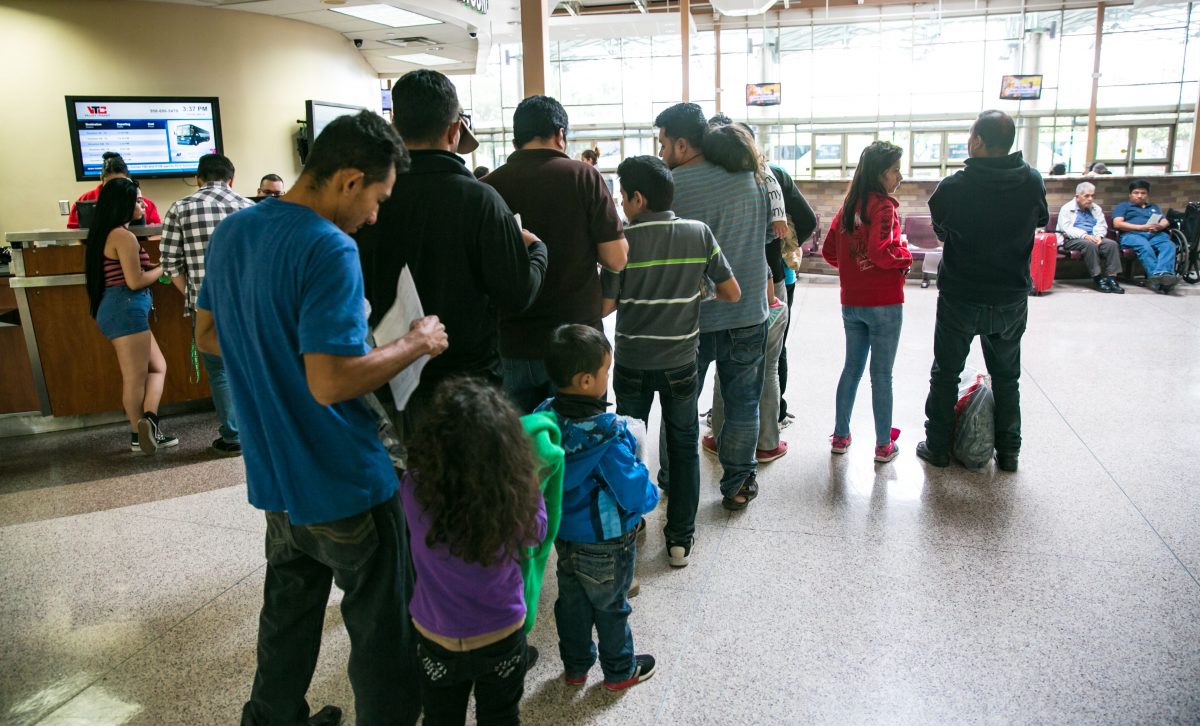 Asylum seekers wait in line to purchase bus tickets in McAllen, Texas, on May 30, 2017. (Benjamin Chasteen/The Epoch Times)