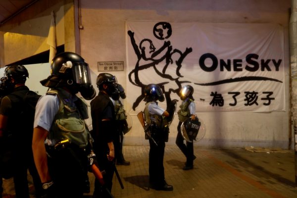 Policemen in riot gear stand guard during a face off with protesters in Hong Kong on Aug. 14, 2019. (Vincent Yu/AP Photo)
