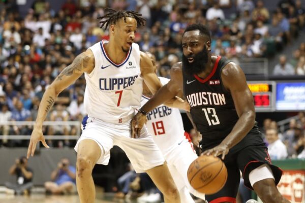 Los Angeles Clippers shooting guard Amir Coffey (7) guards Houston Rockets shooting guard James Harden (13) during the second quarter of an NBA preseason basketball game, in Honolulu, Hawaii. (Marco Garcia/AP Photo)