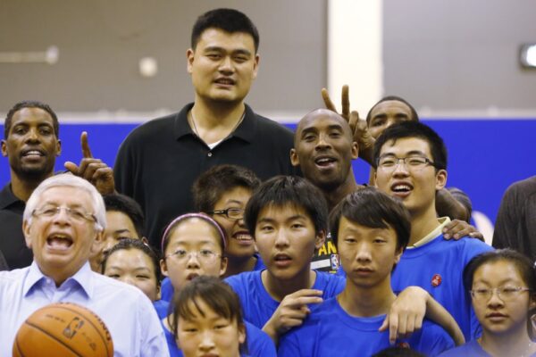 Yao Ming (C-L) during the NBA Cares Special Olympics Basketball Clinic ahead of a 2013–2014 NBA preseason game against the Golden State Warriors in Shanghai, China. (AP Photo/Eugene Hoshiko, File)
