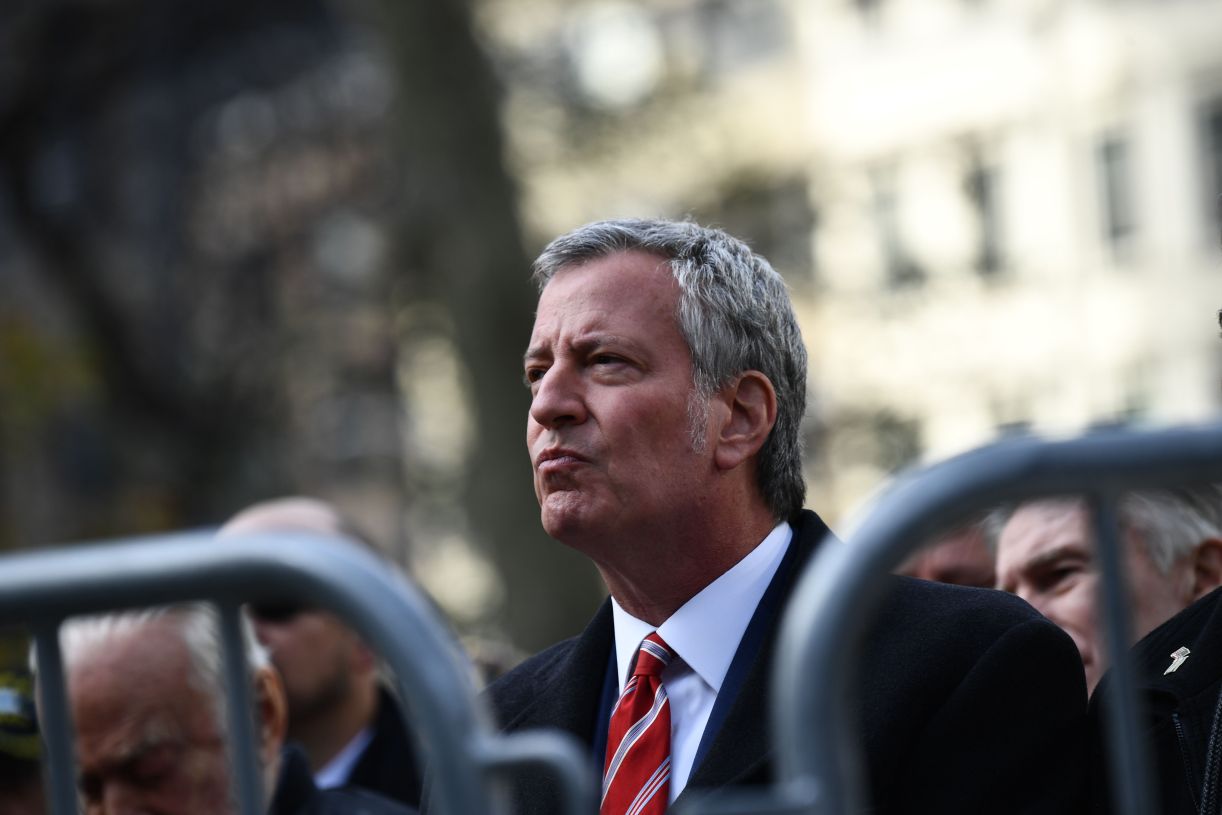New York Mayor Bill de Blasio listens as President Donald Trump delivers remarks at the New York City Veterans Day Parade on Nov. 11, 2019. (Brendan Smialowski/AFP via Getty Images)