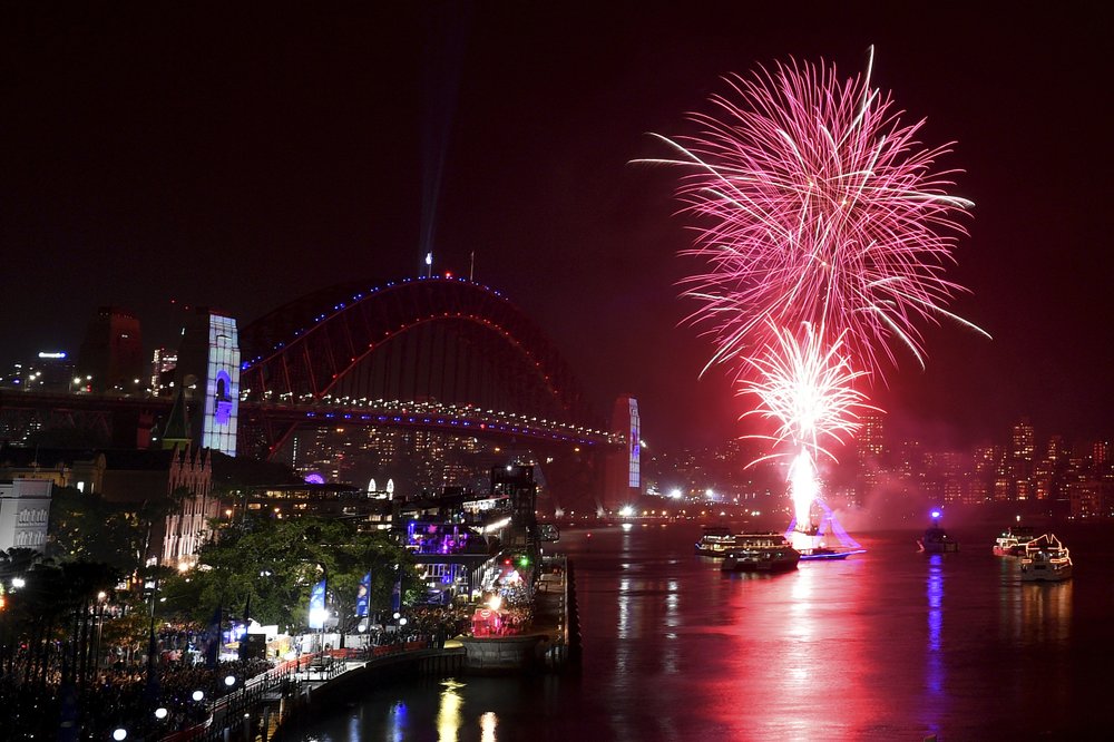 The 9 p.m. family fireworks explode over the Sydney Opera House and Sydney Harbour Bridge on Sydney Harbour during New Year's Eve celebrations in Sydney, on Dec. 31, 2019. (Dean Lewins/AAP Image via AP)