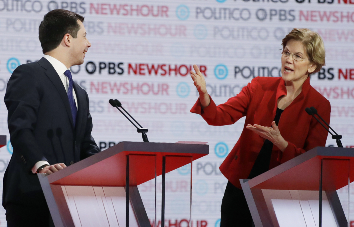 Democratic presidential candidate Sen. Elizabeth Warren (D-Mass.) speaks as South Bend Mayor Pete Buttigieg listens during a Democratic presidential primary debate in Los Angeles on Dec. 19, 2019. (Chris Carlson/AP Photo)