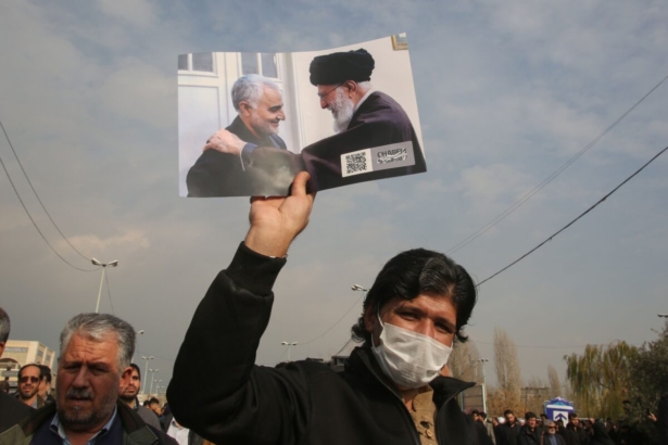 A man holds a picture of Iran's supreme leader Ayatollah Ali Khamenei