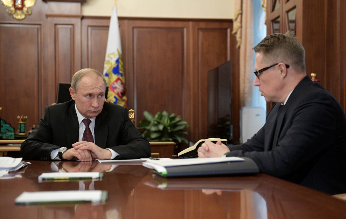 Russian President Vladimir Putin listens to Health Minister 