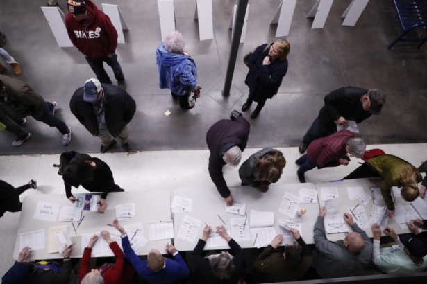 Caucus goers check in at a caucus