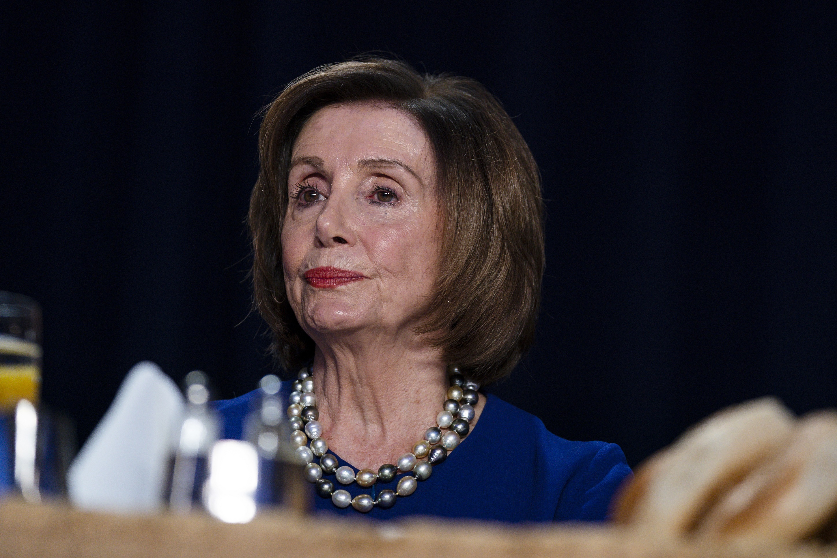 House Speaker Nancy Pelosi (D-Calif.) listens as President Donald Trump speaks at the 68th annual National Prayer Breakfast at the Washington Hilton on Feb. 6, 2020. (Evan Vucci/AP Photo)