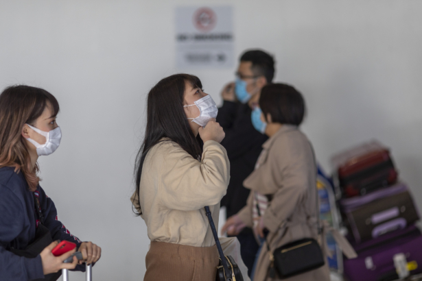 Travelers arrive at LAX Tom Bradley International Terminal wearing medical masks for protection against the novel coronavirus outbreak in Los Angeles, Calif. on Feb. 2, 2020. (David McNew/Getty Images)