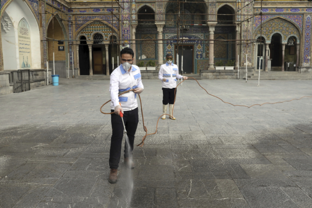 Workers disinfect the shrine of the Shiite Saint Imam Abdulazim to help prevent the spread of the new coronavirus in Shahr-e-Ray, south of Tehran, Iran, on March 7, 2020. (Ebrahim Noroozi/AP Photo)