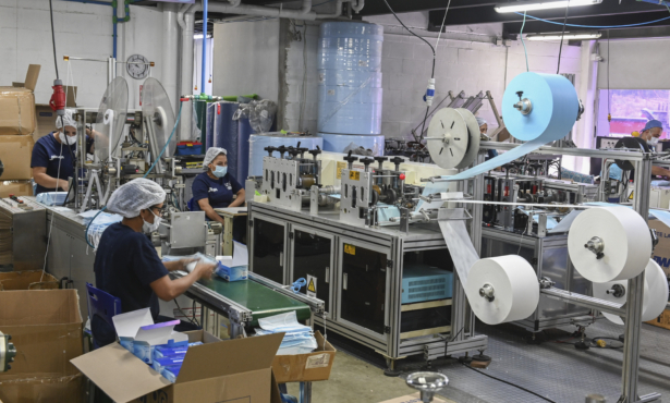 Women work in the assembly line of protective face masks at the JMM health supplies company, in Sabaneta, near Medellin, Colombia, on March 9, 2020. (Joaquin Sarmiento/AFP via Getty Images)