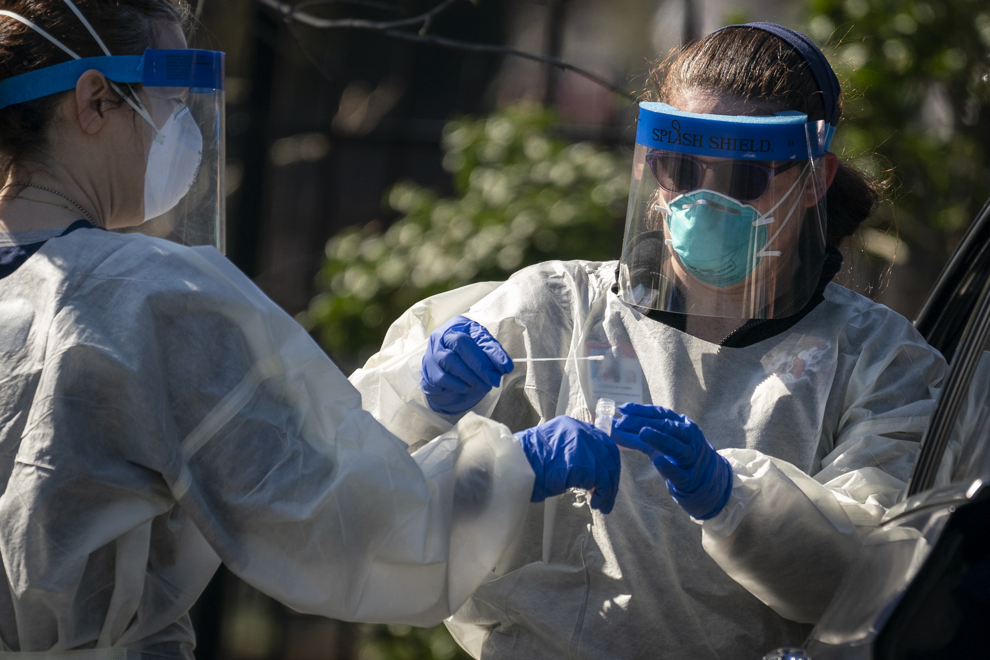 Medical professionals from Children's National Hospital administer a CCP virus test at a drive-thru testing site for young people age 22 and under at Trinity University in Washington on April 2, 2020. (Drew Angerer/Getty Images)