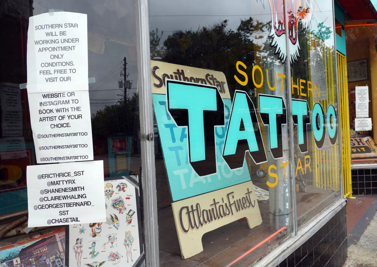 A sign on the window of Southern Star Tattoo informs customers that tattoos are by appointment only in Little Five Points in Atlanta, Georgia, on April 23, 2020. (Tami Chappell/AFP via Getty Images)