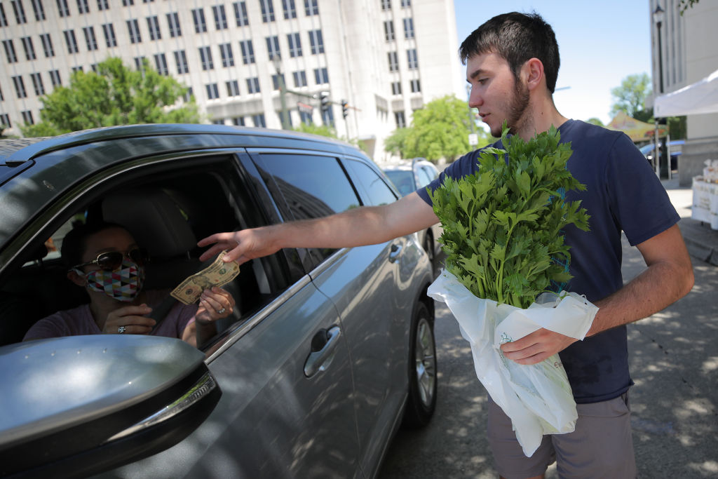 A person buys produce at a drive through farmer's market in Baton Rouge, Louisiana on April 25, 2020. (Chris Graythen/Getty Images)