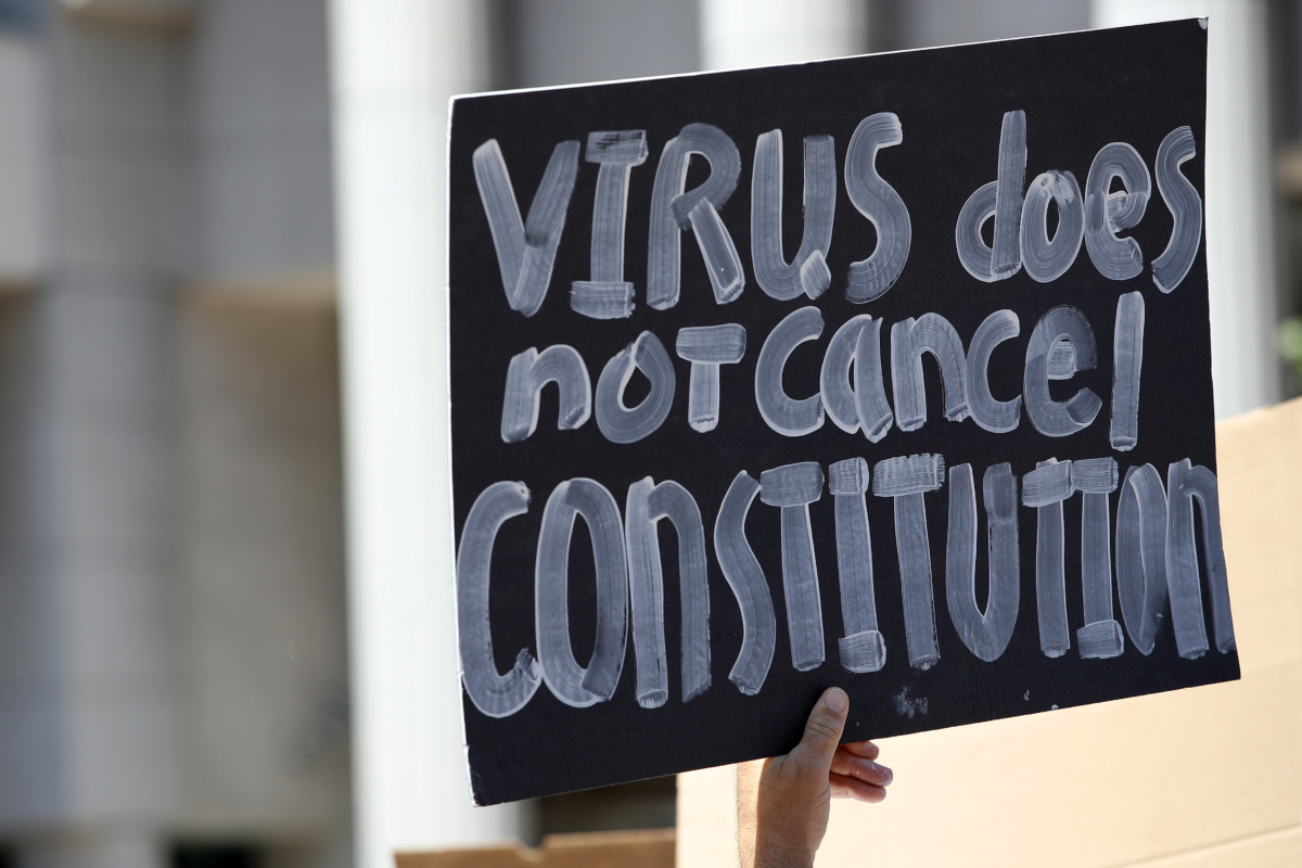 Activists hold signs and protest the California lockdown due to the CCP virus pandemic, in San Diego, Calif. on May 1, 2020. (Sean M. Haffey/Getty Images)