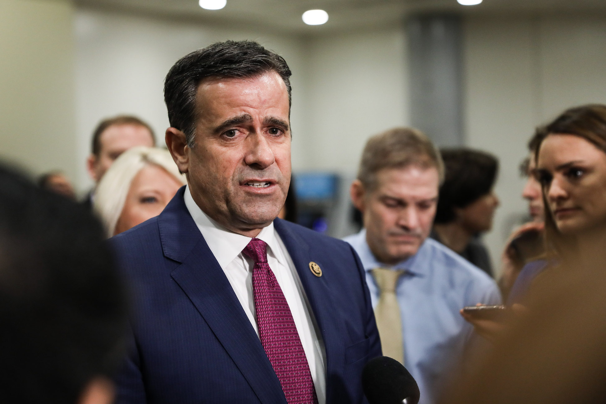 Rep. John Ratcliffe (R-Texas) speaks to media while other impeachment defense team advisers look on, at the Capitol in Washington on Jan. 27, 2020. (Charlotte Cuthbertson/The Epoch Times)