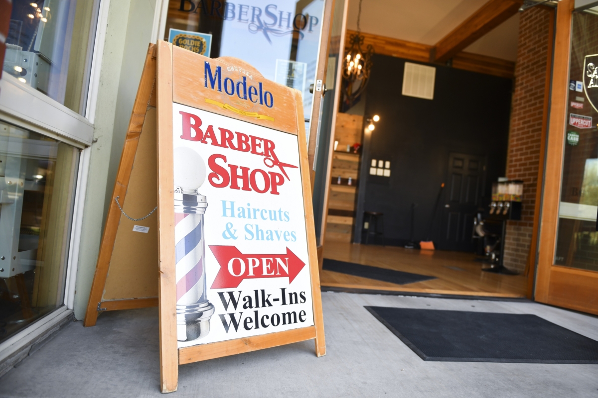 An open sign sits outside The Bar.Ber.Shop in Greeley, Colo., on April 28, 2020. (Michael Ciaglo/Getty Images)