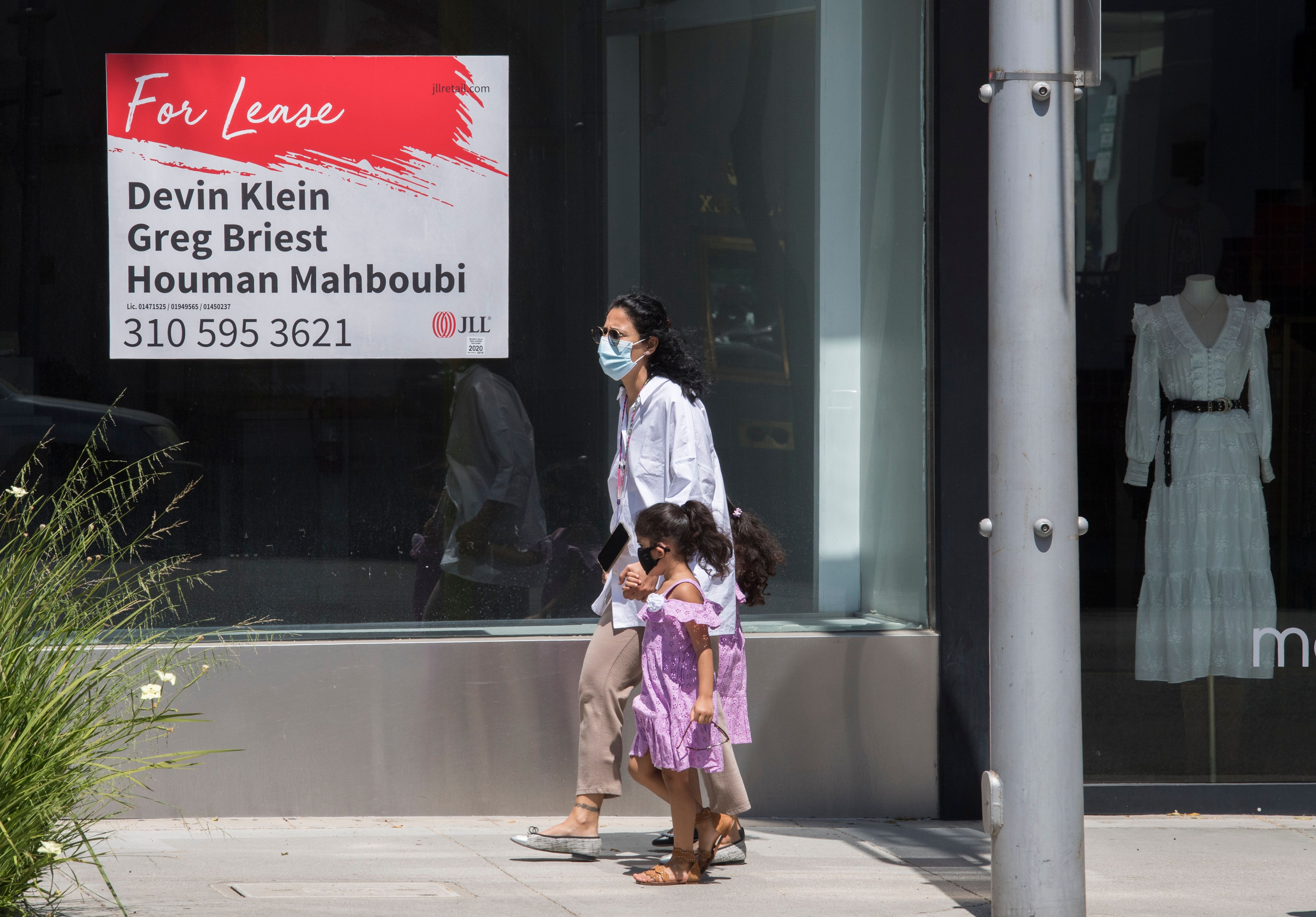 People walk past empty stores and restaurants closed due to impact of the CCP virus in Beverly Hills, California, on May 8, 2020. (Mark Ralston/AFP via Getty Images)