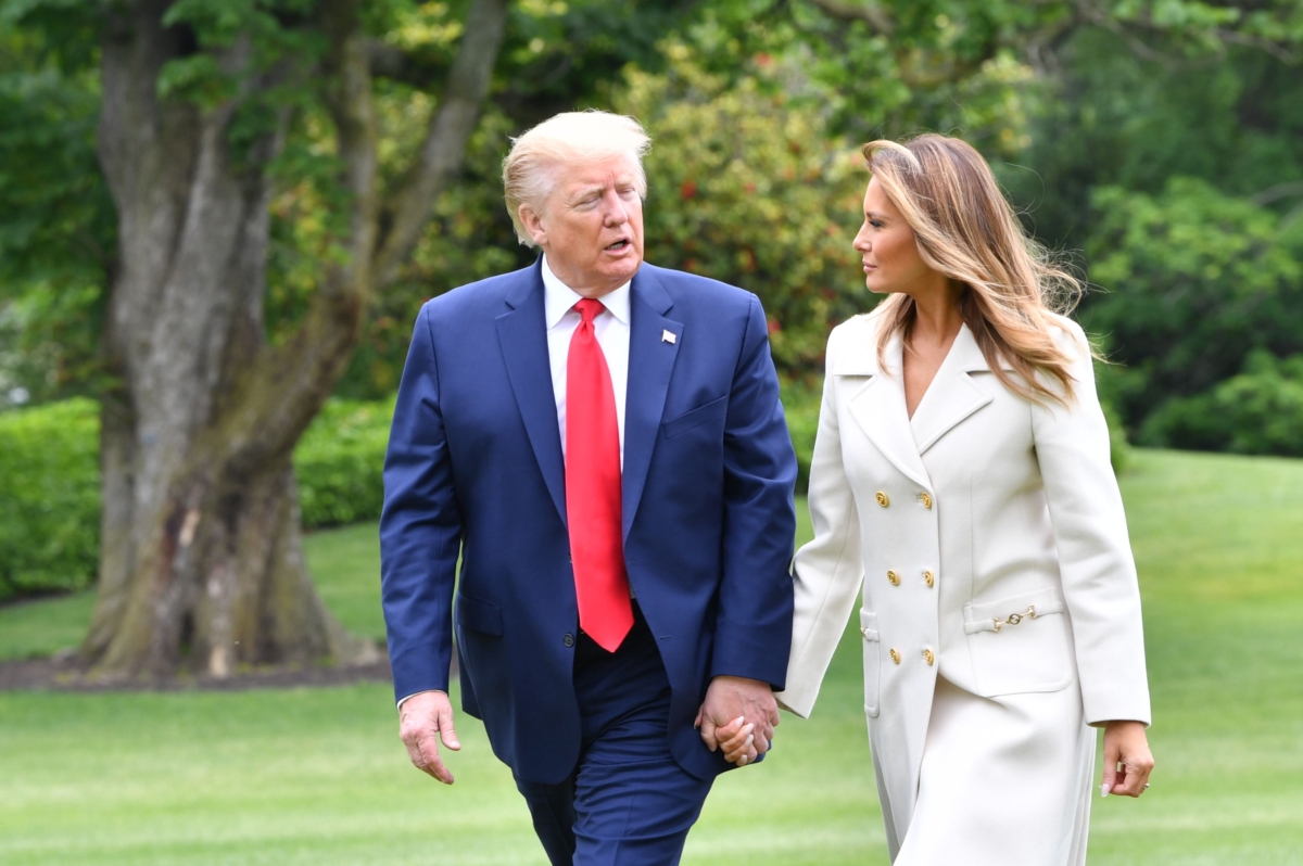 President Donald Trump and First Lady Melania Trump walk from Marine One at the White House, in Washington on May 25, 2020, after a visit to Fort McHenry in Baltimore, Md. (Nicholas Kamm/AFP via Getty Images)