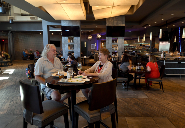 A couple dines at Kona Grill in Boca Park Fashion Village in Las Vegas, Nev., on May 9, 2020. (Ethan Miller/Getty Images)