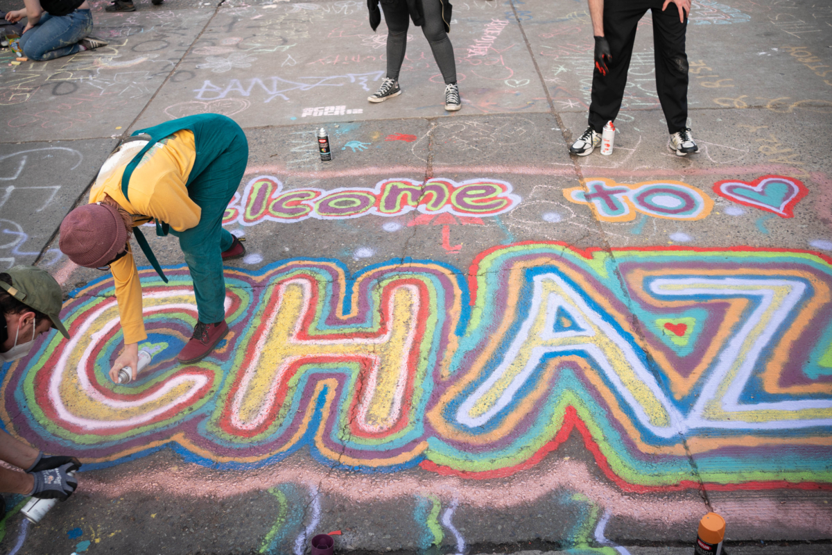 People paint an acronym for "Capitol Hill Autonomous Zone", in Seattle, Wash., on June 10, 2020. (David Ryder/Getty Images)
