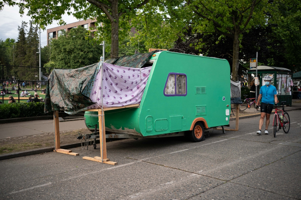 A person walks by a camping trailer in the so-called "Capitol Hill Autonomous Zone" , in Seattle, Wash., on June 10, 2020. (David Ryder/Getty Images)
