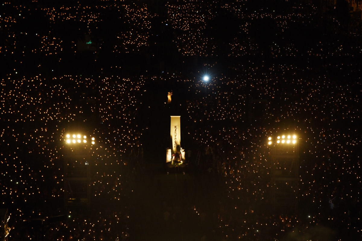 Participants hold candles as the Goddess of Democracy statue (C) is seen at Hong Kong's Victoria Park on June 4, 2017, during a candlelight vigil to mark the 28th anniversary of the 1989 Tiananmen crackdown in Beijing. (Anthony Wallace/AFP via Getty Images)