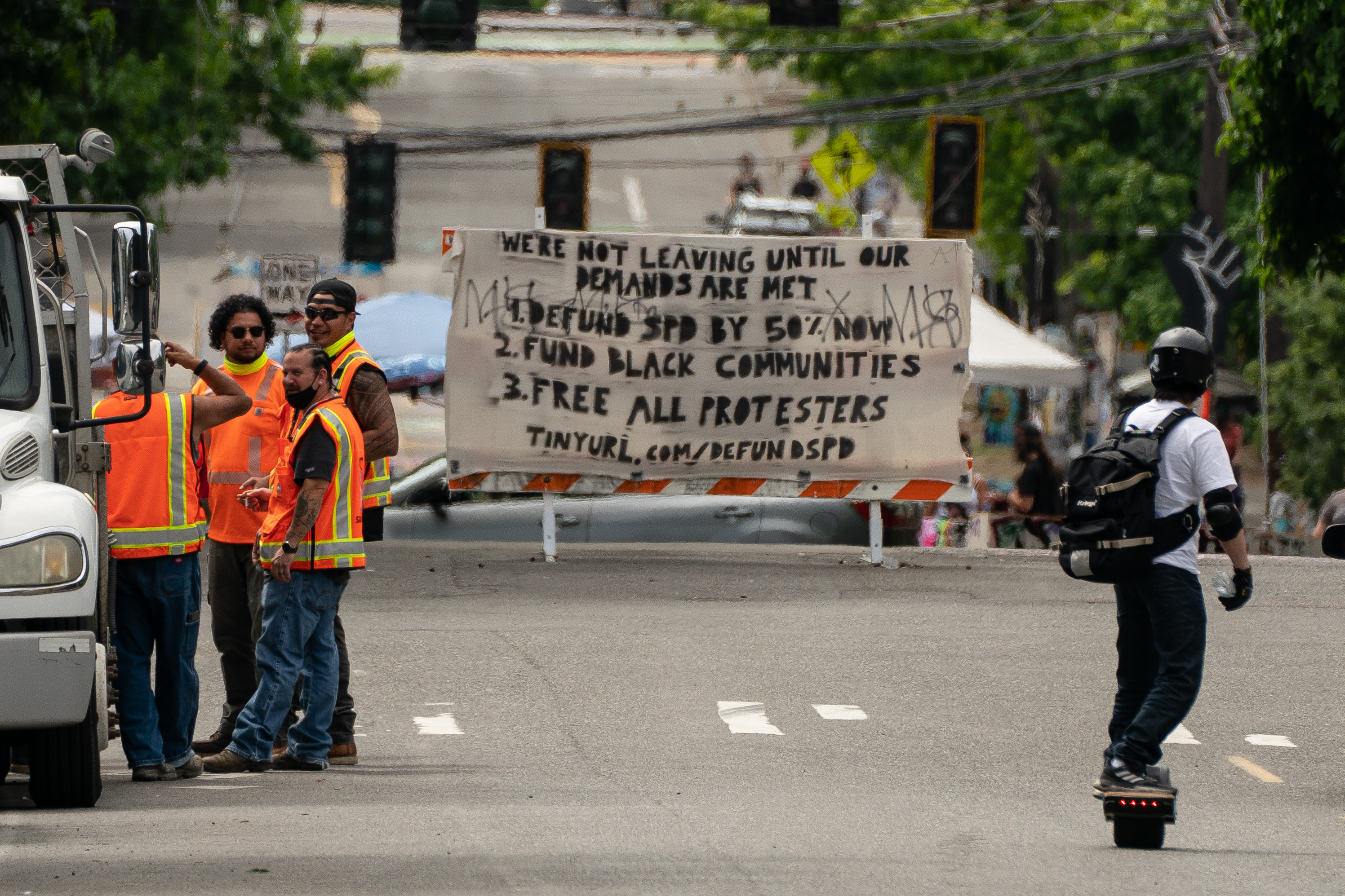 Personnel from the Seattle Department of Transportation wait near an entrance to the area known as the Capitol Hill Organized Protest (CHOP) in Seattle, Wash., on June 26, 2020. (David Ryder/Getty Images)