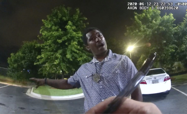 Rayshard Brooks speaking with officer Garrett Rolfe as Rolfe writes notes during a field sobriety test in the parking lot of a Wendy's restaurant in Atlanta, Ga., late June 12, 2020. (Atlanta Police Department via AP)