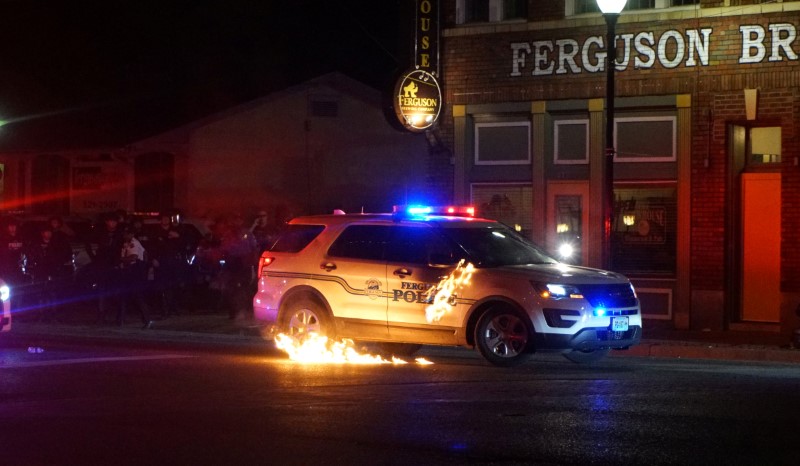 A Molotov cocktail hits a police car