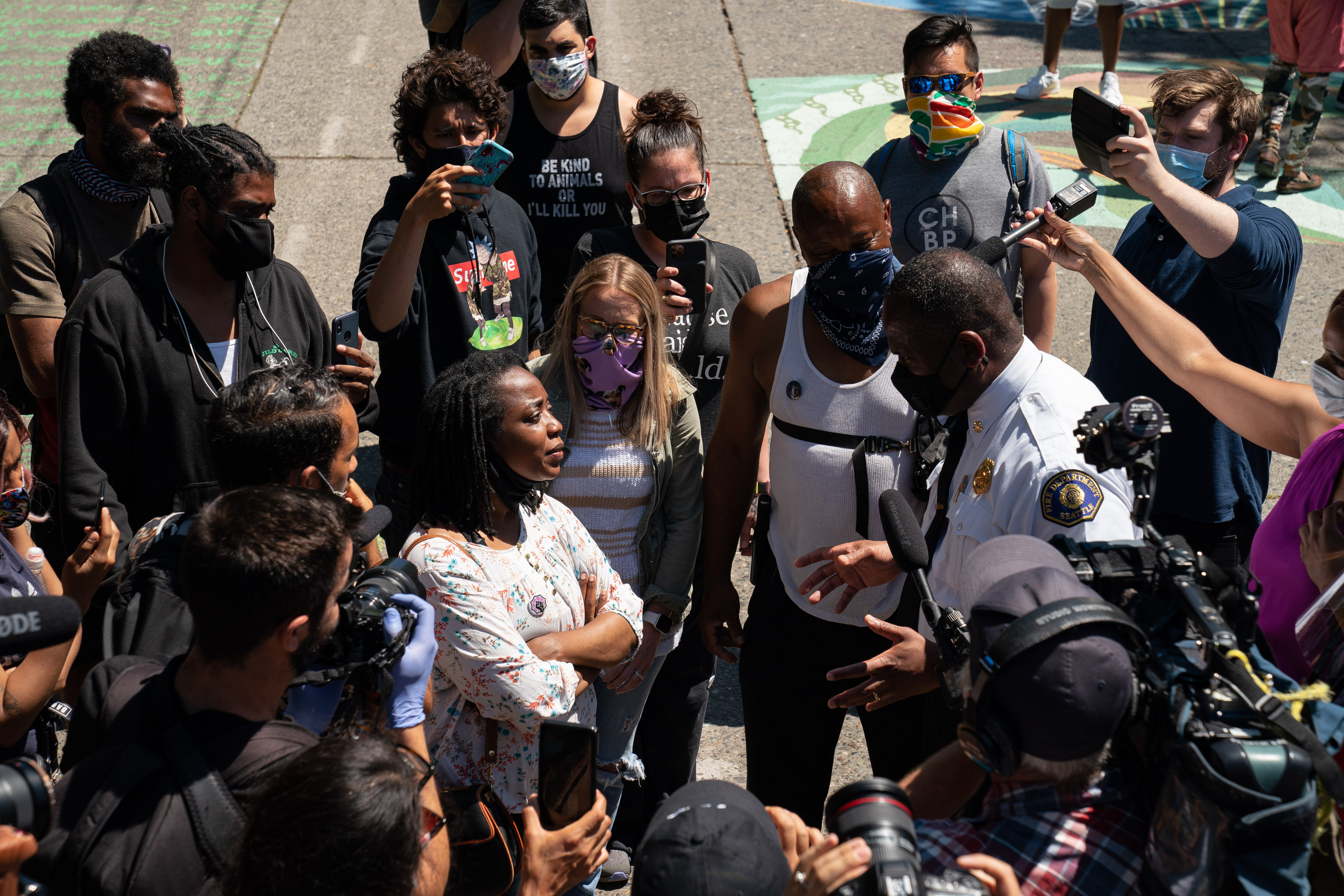 Seattle Fire Chief Harold Scoggins speaks with occupiers while walking through the area known as the Capitol Hill Organized Protest (CHOP) in Seattle, Wash., on June 26, 2020. (David Ryder/Getty Images)