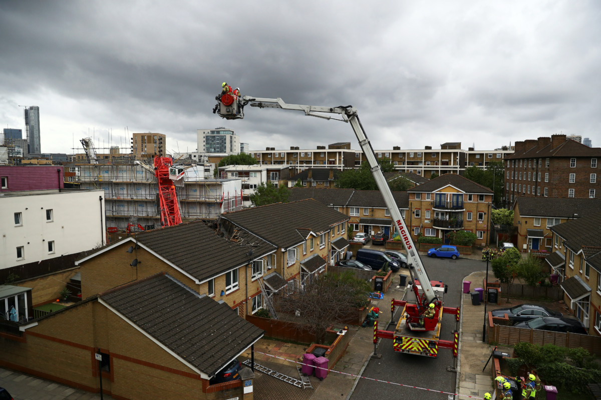 Rescue personnel work at the area where a crane collapsed in Bow, east London, Britain, on July 8, 2020. (Hannah McKay/Reuters)