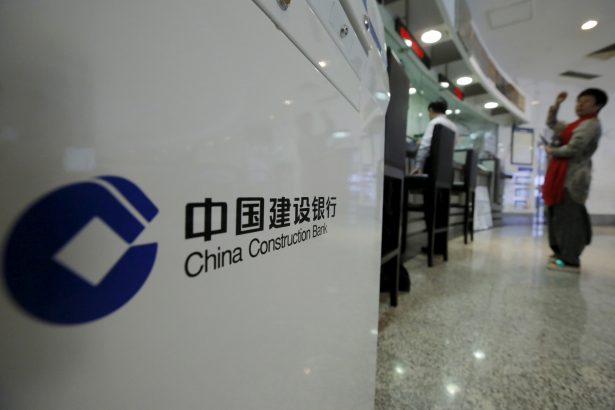 A customer waits at a counter of a branch of China Construction Bank Corp (CCB) at its headquarters in Beijing, China, on March 31, 2016. (Kim Kyung-Hoon/Reuters)