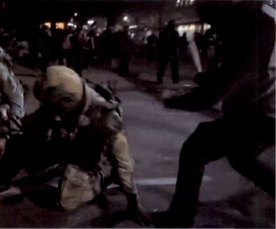 A man, right, that authorities say was Dakotah Ray Horton, 24, hits a federal officer with a baseball bat during rioting in Portland, Ore., on July 27, 2020. (Department of Justice)