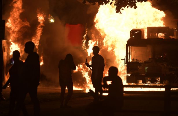 Garbage and dump trucks were set ablaze by rioters near the Kenosha County Courthouse where they had been set up to prevent damage to the building, in Kenosha, Wis., on Aug. 23, 2020. (Sean Krajacic/Kenosha News via AP)