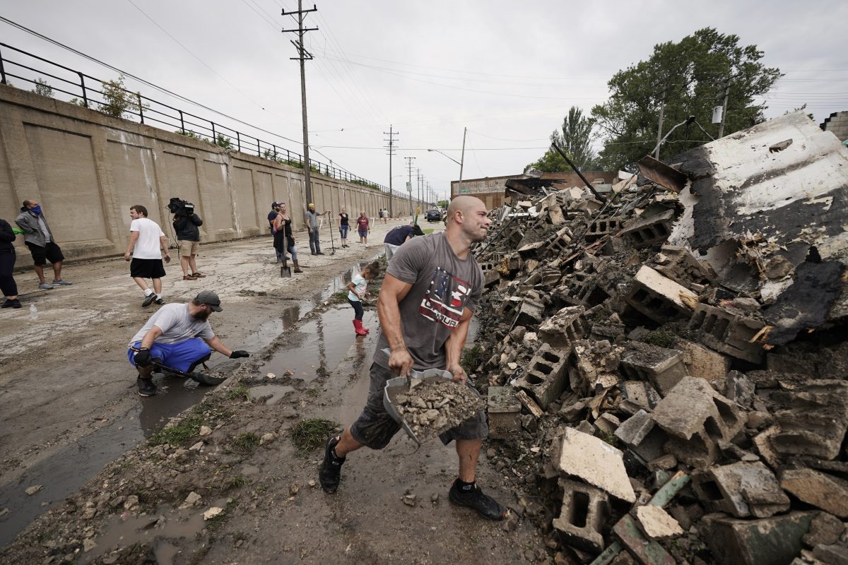 Volunteers clean up the Kenosha County Department of Corrections building after it was burned to the ground during rioting in Kenosha, Wis., on Aug. 25, 2020. (Morry Gash/AP Photo)