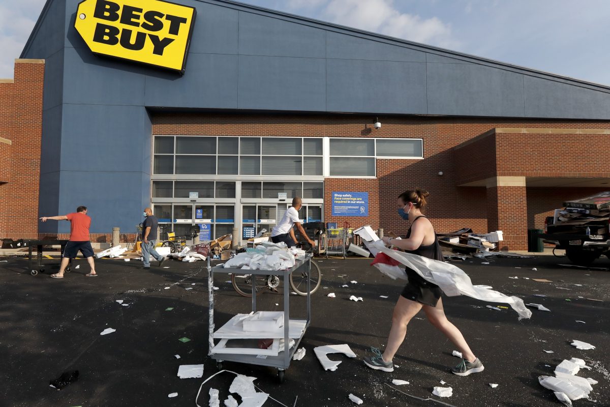 Volunteers help clean up the parking lot outside a Best Buy store in Chicago on Aug. 10, 2020. (Charles Rex Arbogast/AP Photo)