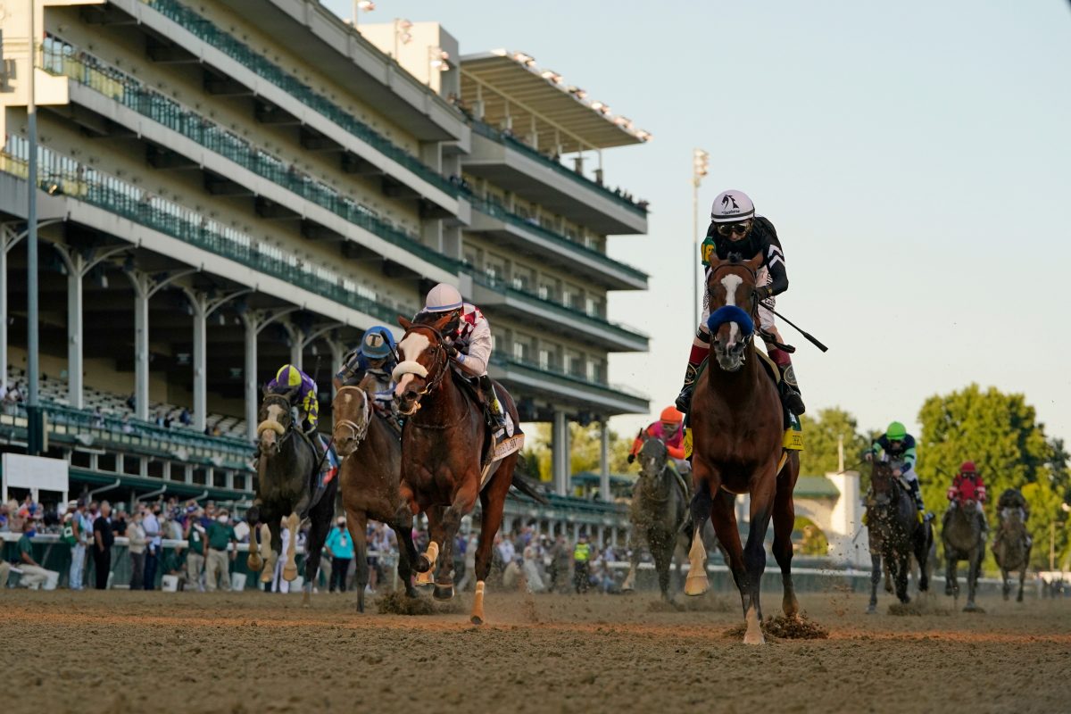 Jockey John Velazquez riding Authentic (R) crosses the finish line to win the 146th running of the Kentucky Derby at Churchill Downs, in Louisville, Ky., on Sept. 5, 2020. (Jeff Roberson/AP Photo)
