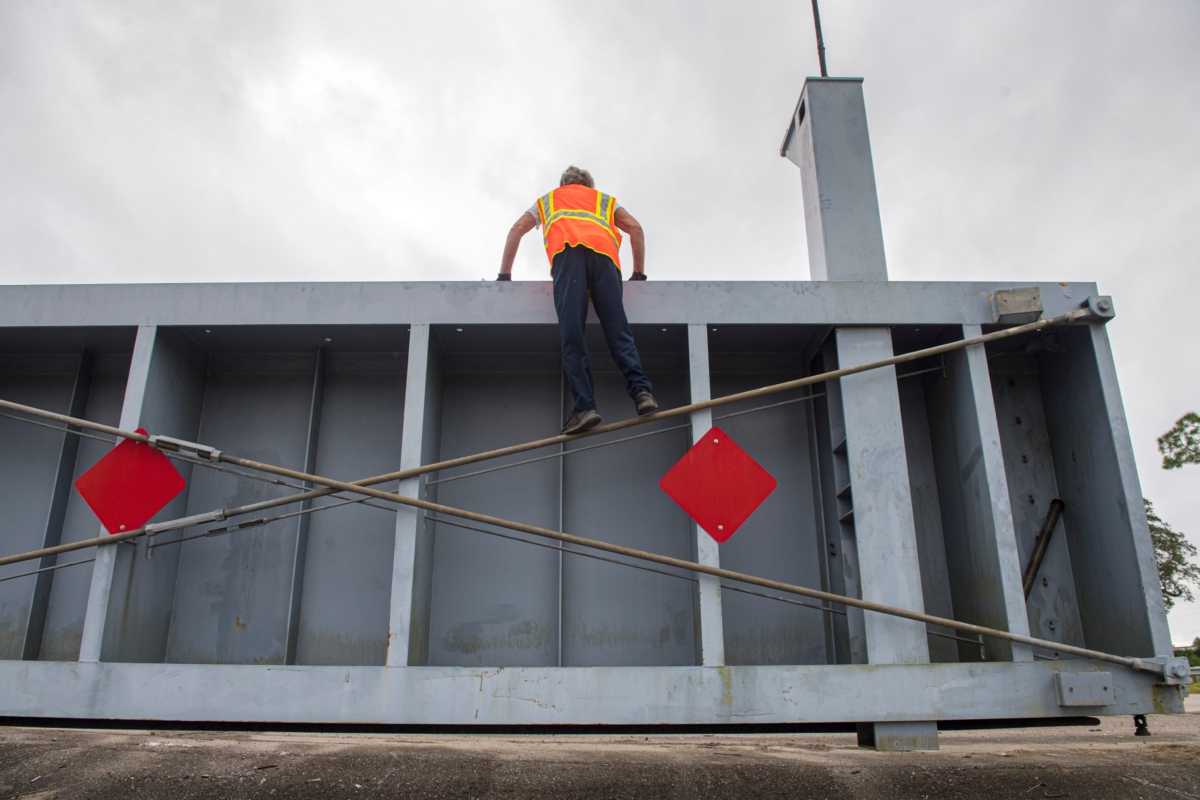 Crews prepare to move a levee gate as they get ready for Hurricane Sally in Plaquemines Parish, La., on Sept. 14, 2020. (Chris Granger/The Advocate via AP)