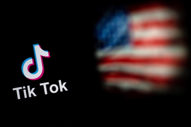 The logo of the social network application TikTok and a U.S. flag are shown on the screens of two laptops in Beijing, China, on Sept. 14, 2020. (Nicolas Asfouri/AFP via Getty Images)