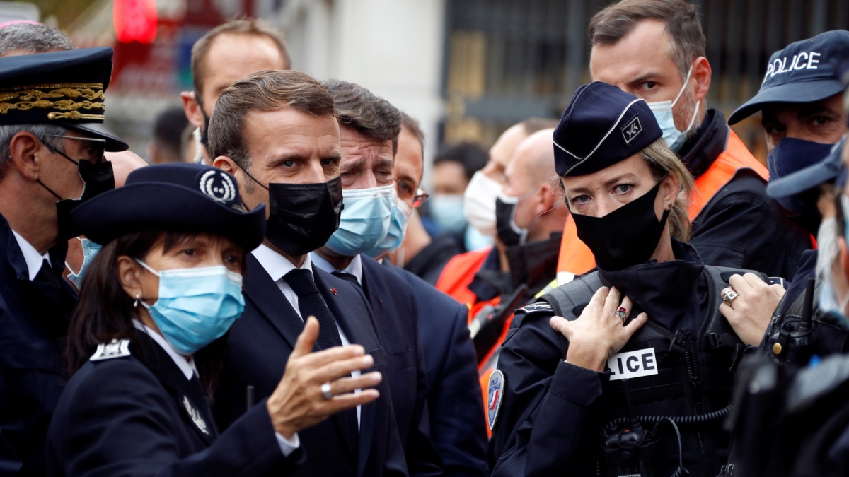 French President Emmanuel Macron, second left, and Nice mayor Christian Estrosi, third left, meet police officers after a knife attack at Notre Dame church in Nice, southern France, on Oct. 29, 2020. (Eric Gaillard/Pool via AP)