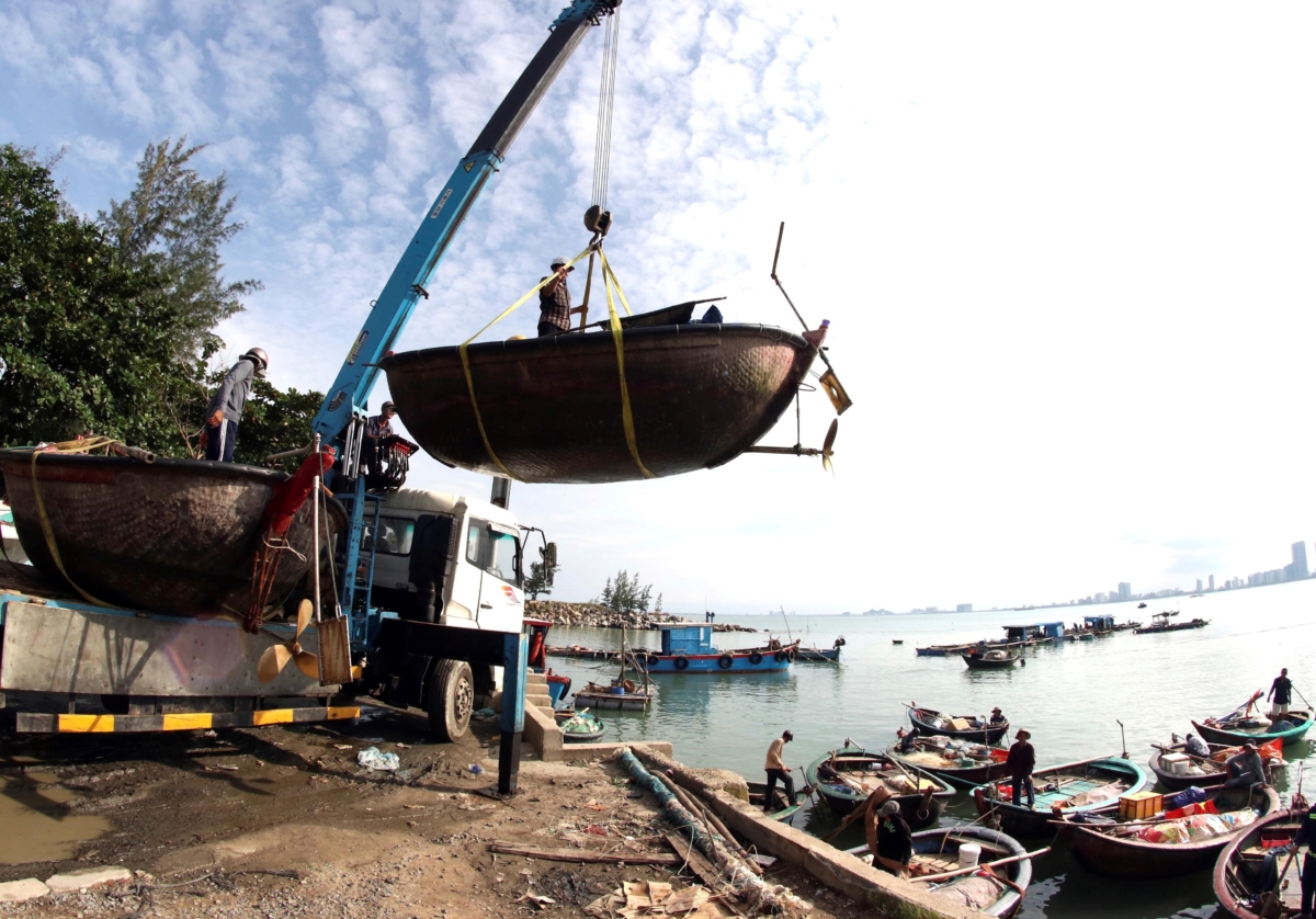 People move fishing boats to save place ahead of Typhoon Molave in Danang, Vietnam, on Oct. 26, 2020. (Tran Le Lam/VNA via AP)