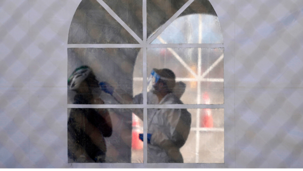 A health care worker gives a test at a COVID-19 testing site in San Francisco, Calif., on Nov. 16, 2020. (Jeff Chiu/AP Photo)