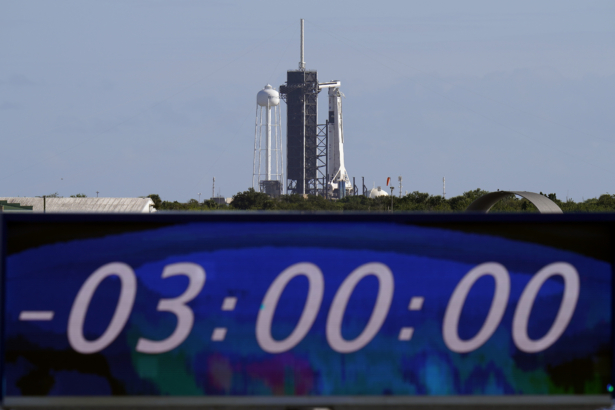 The countdown clock is stopped at a three-hour built in hold as a SpaceX Falcon 9 rocket, with the company's Crew Dragon capsule attached, sits on the launch pad at Launch Complex 39A, at the Kennedy Space Center in Cape Canaveral, Fla., on Nov. 15, 2020. (Chris O'Meara/AP Photo)