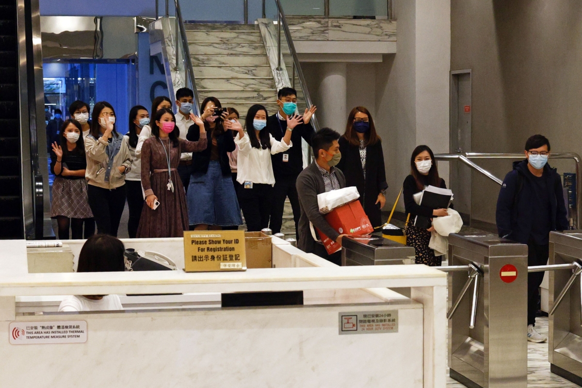 i-Cable TV news journalists leave with their boxes after being laid off in Hong Kong, on Dec.1, 2020. (Tyrone Siu/Reuters)